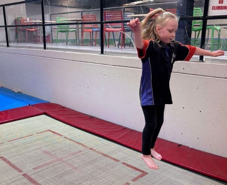 Photo of student in the air after jumping off a trampoline.